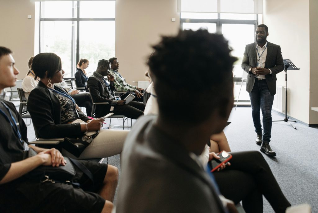 Diverse professionals engaged in an interactive business presentation in a modern conference room.